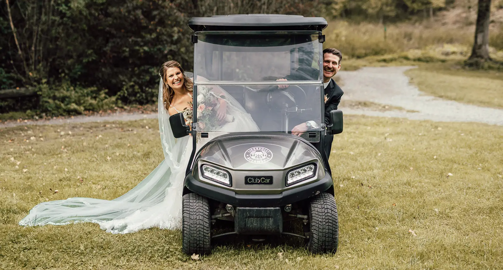 Brautpaar im Clubcar auf dem Gelände der Auermühle